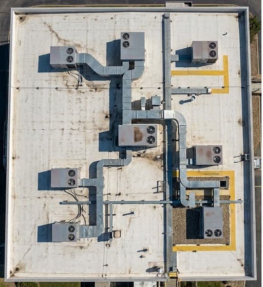 Visual daylight photo of a flat TPO commercial membrane roof